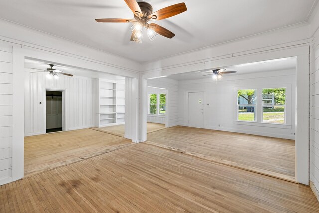 unfurnished living room featuring wood finished floors, a ceiling fan, and plenty of natural light