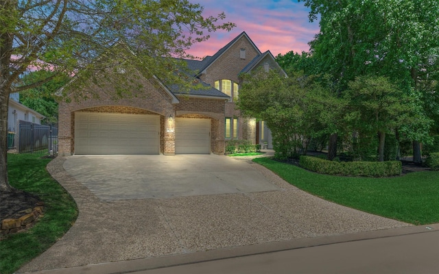 view of front facade featuring brick siding, driveway, and a garage
