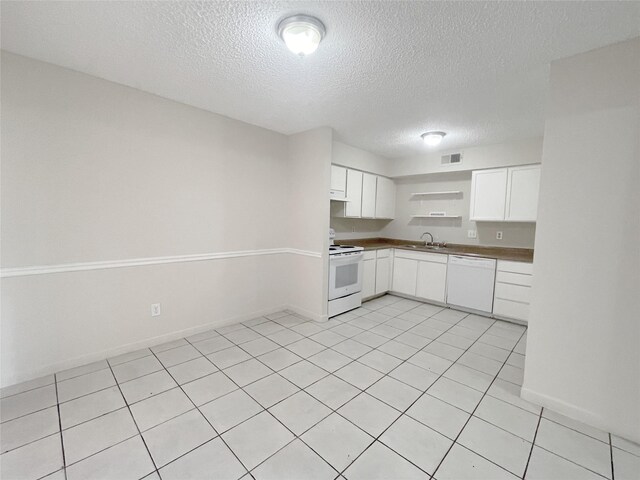 12023 Greenwood Forest Dr Unit B, Houston, TX 77066 - kitchen with visible vents, white cabinets, a sink, white appliances, and a textured ceiling