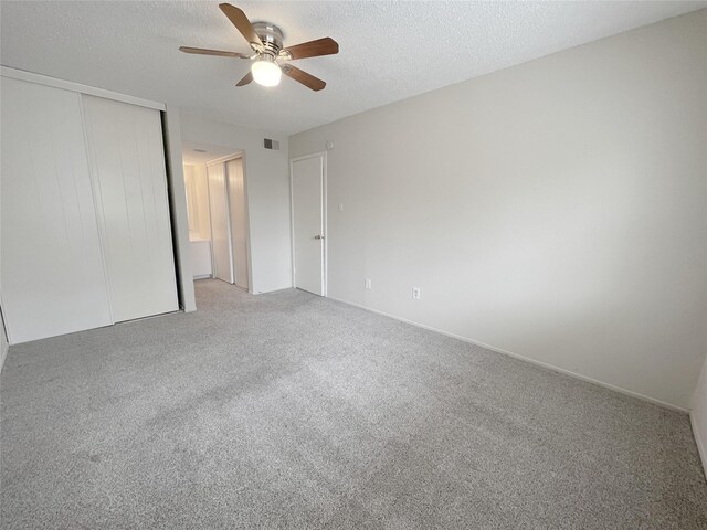 12023 Greenwood Forest Dr Unit B, Houston, TX 77066 - unfurnished bedroom featuring visible vents, a closet, ceiling fan, a textured ceiling, and light colored carpet