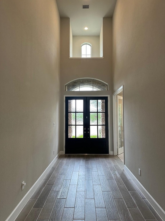 doorway with visible vents, baseboards, wood tiled floor, and french doors