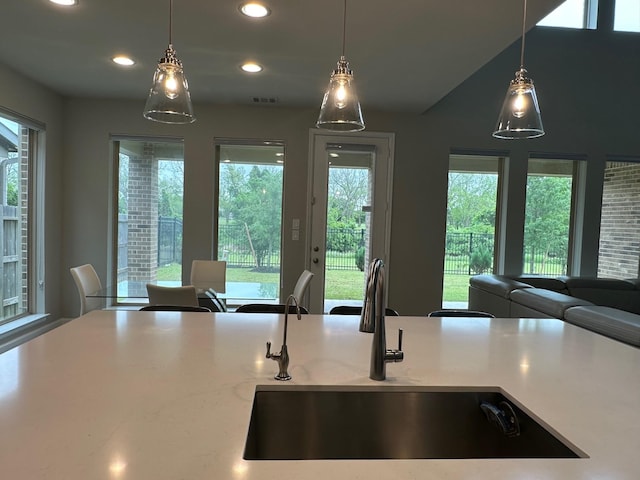 kitchen featuring open floor plan, a healthy amount of sunlight, a sink, and visible vents