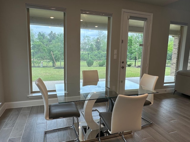 dining area with baseboards and hardwood / wood-style floors