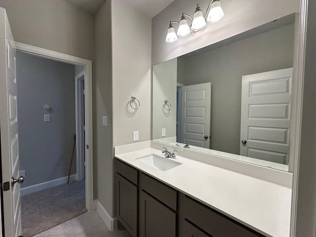 bathroom with baseboards and vanity