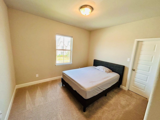 carpeted bedroom with baseboards