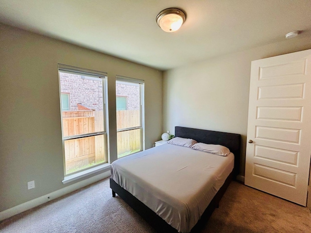 carpeted bedroom featuring baseboards