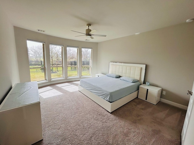 bedroom featuring ceiling fan, baseboards, visible vents, and carpet floors