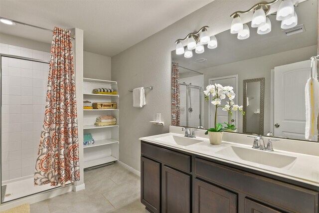 full bathroom with tile patterned flooring, a sink, visible vents, and a stall shower