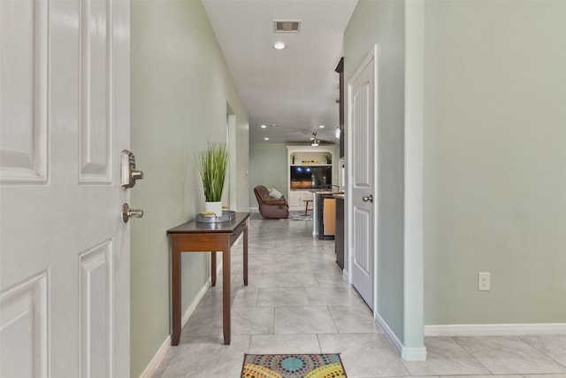hallway featuring baseboards, visible vents, and recessed lighting