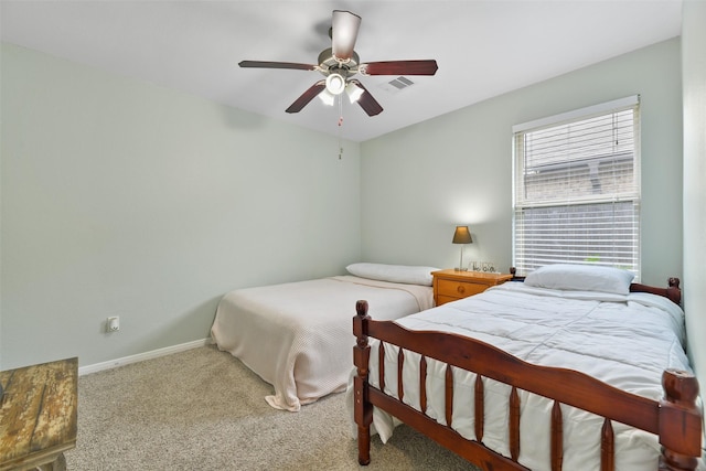 bedroom with ceiling fan, baseboards, carpet flooring, and visible vents