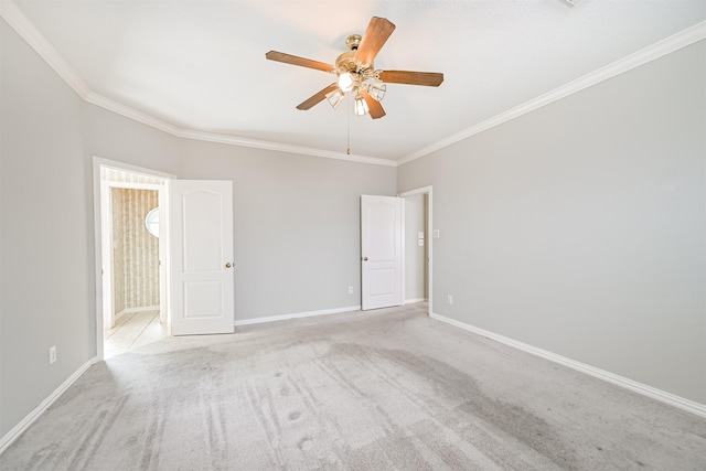 unfurnished room featuring ceiling fan, carpet floors, baseboards, and ornamental molding