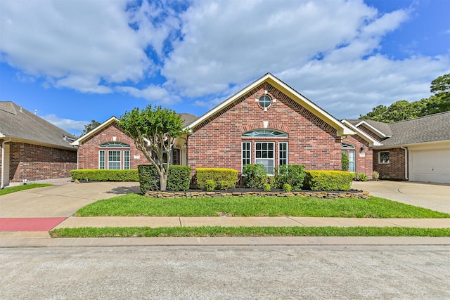 view of front of property featuring brick siding and concrete driveway