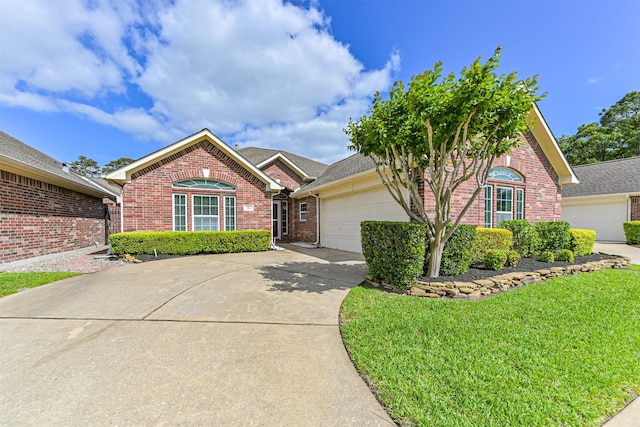 ranch-style house with brick siding, a front yard, driveway, and a garage