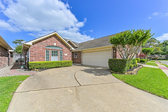 single story home with an attached garage, brick siding, and driveway