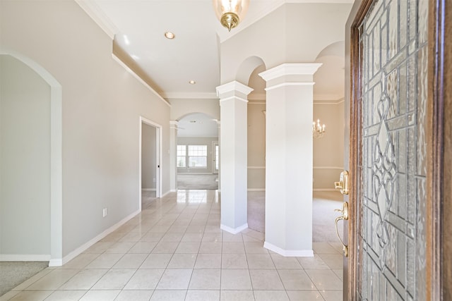 hallway with crown molding, light tile patterned floors, arched walkways, baseboards, and recessed lighting