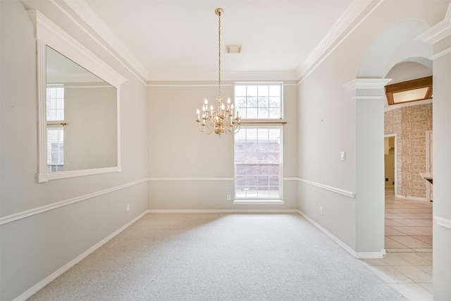 carpeted spare room with tile patterned floors, visible vents, ornamental molding, baseboards, and a notable chandelier