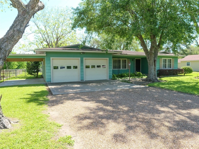 single story home with a carport, driveway, a front lawn, a garage, and fence