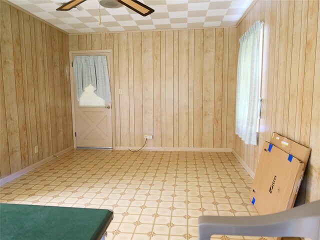 spare room featuring wood walls and tile patterned floors