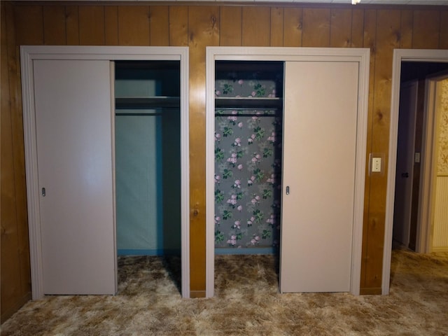 unfurnished bedroom with carpet and multiple closets