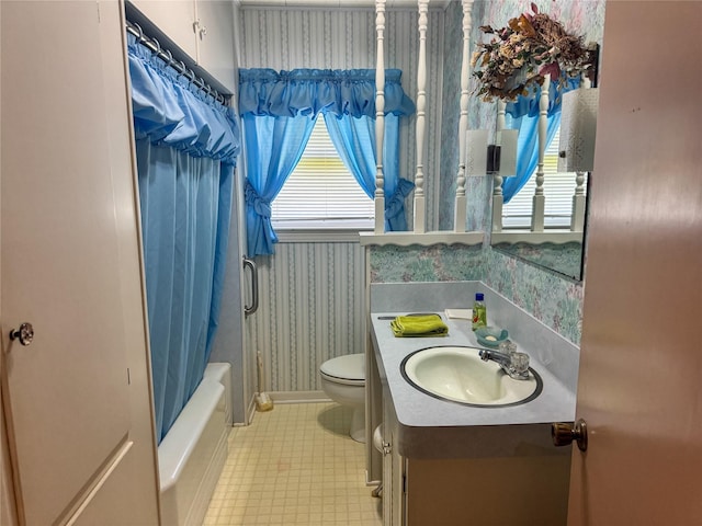 full bathroom featuring toilet, shower / tub combo with curtain, vanity, wallpapered walls, and tile patterned flooring