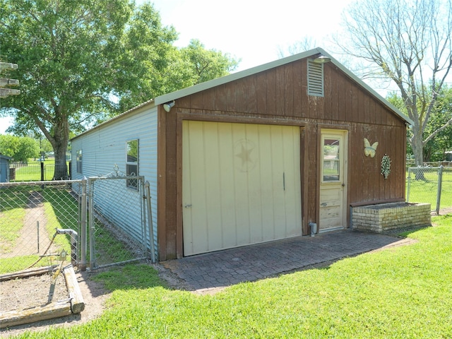 view of outdoor structure with fence and an outbuilding