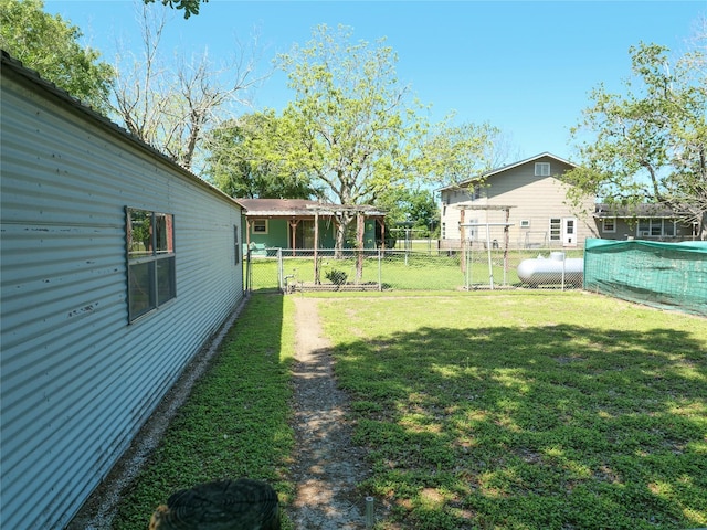 view of yard featuring fence and a gate