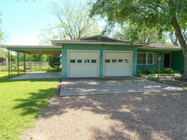 exterior space featuring an attached garage, driveway, a front yard, and fence