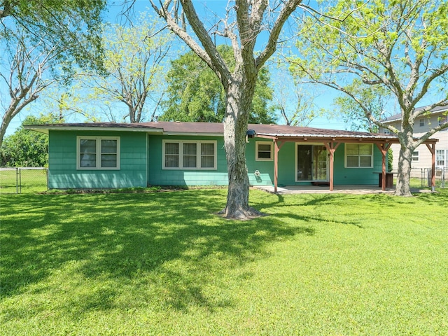 back of house featuring a patio, a yard, and fence