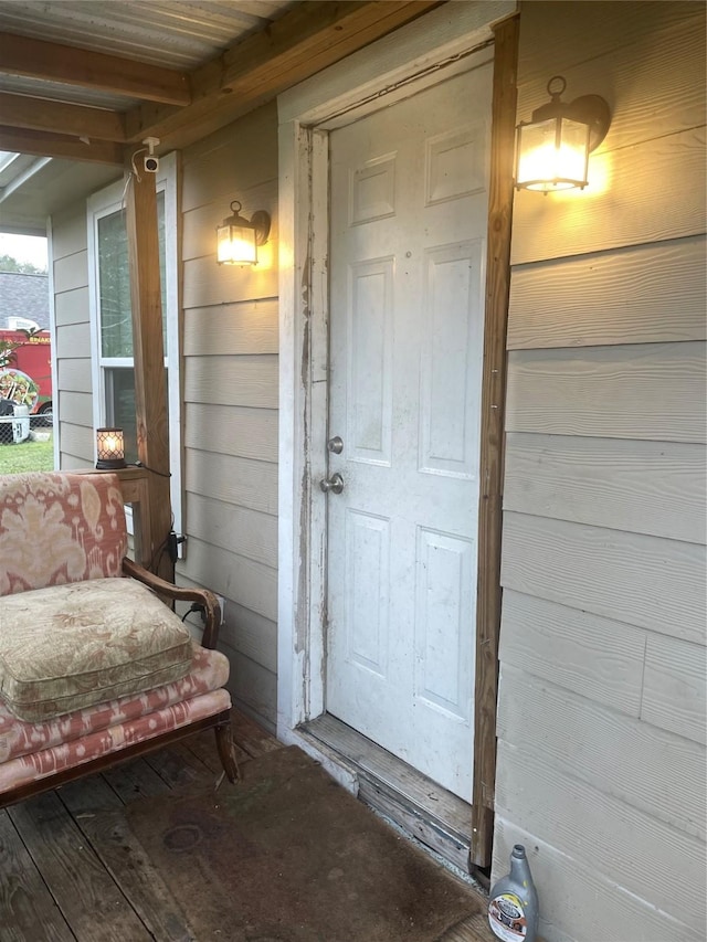 view of exterior entry featuring a porch