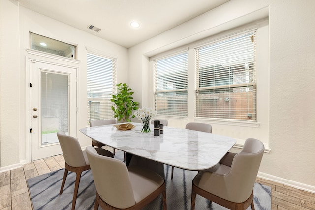 dining area featuring wood finished floors, baseboards, visible vents, and recessed lighting