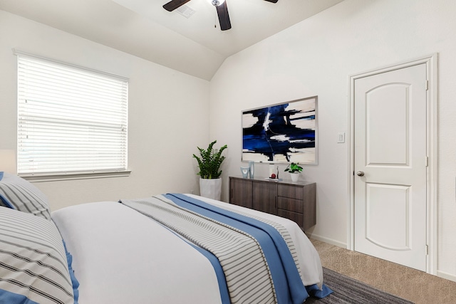 bedroom with visible vents, baseboards, ceiling fan, carpet floors, and lofted ceiling
