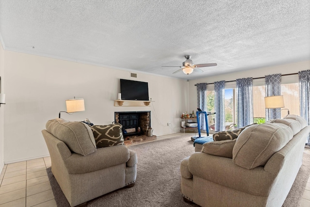 living room with a textured ceiling, ceiling fan, baseboards, and a fireplace with raised hearth