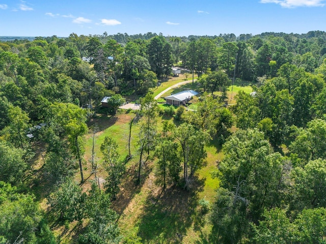 drone / aerial view featuring a wooded view