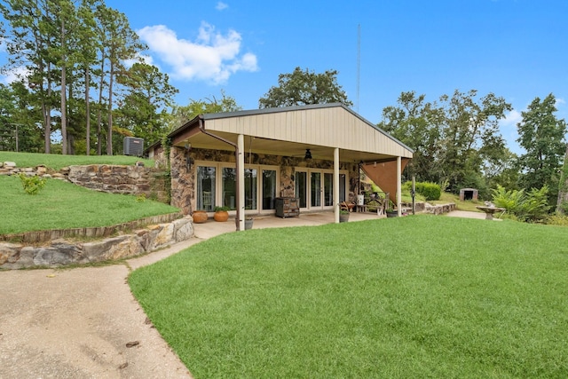 back of house with french doors, a yard, a patio area, and ceiling fan