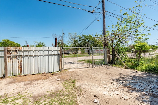 view of yard with fence and a gate
