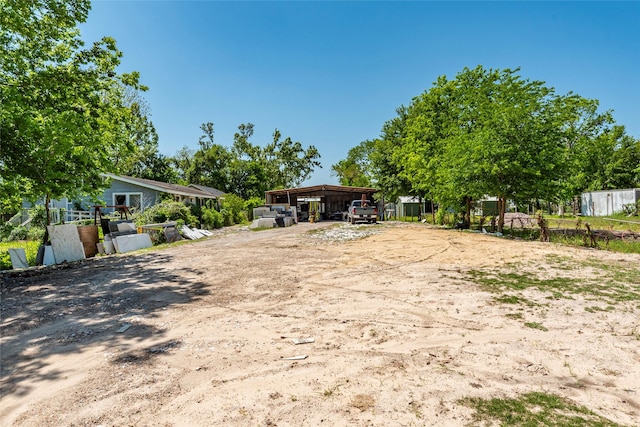 view of yard with fence and a pole building