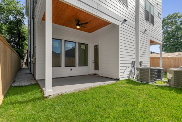 back of property with fence, cooling unit, a patio, a ceiling fan, and a lawn