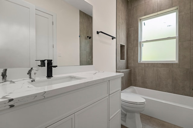 bathroom featuring toilet, shower / bathtub combination, and vanity