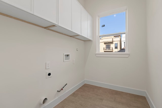 washroom featuring gas dryer hookup, baseboards, cabinet space, and hookup for a washing machine