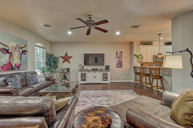 living room with recessed lighting, visible vents, dark wood-style flooring, and ceiling fan