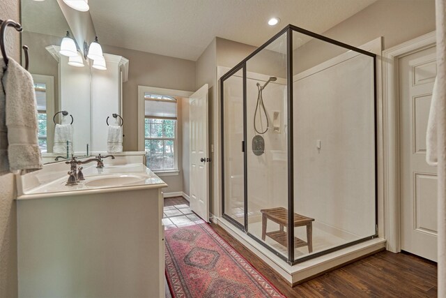 bathroom featuring a stall shower and vanity