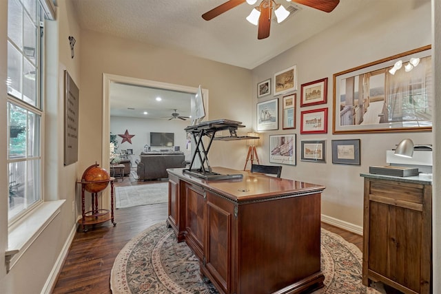 office area featuring dark wood finished floors, baseboards, and a ceiling fan