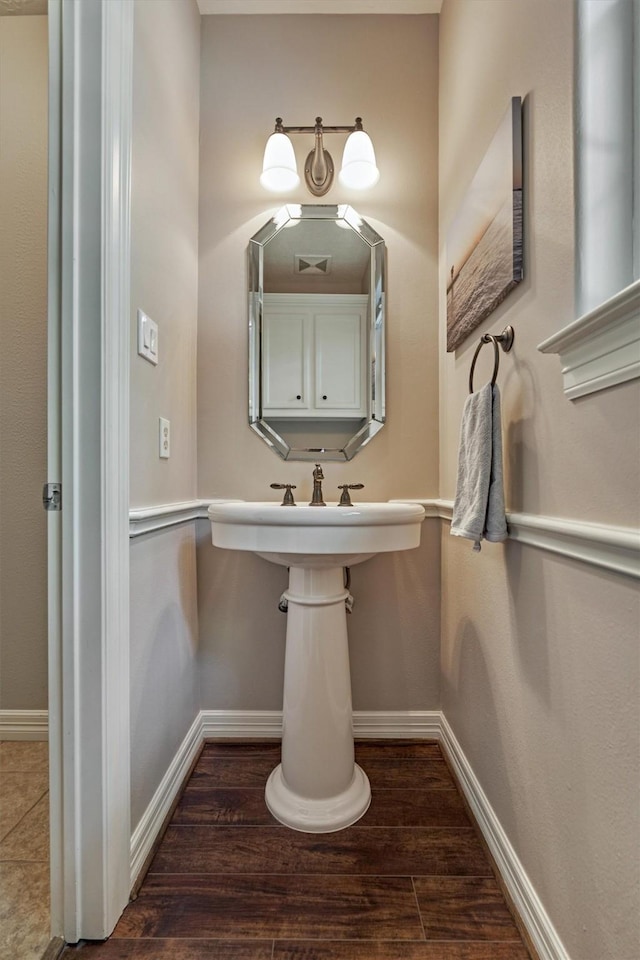 bathroom featuring baseboards and wood finished floors