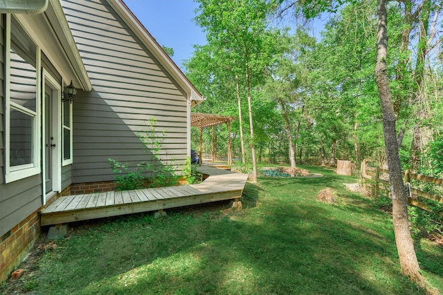 view of yard with a wooden deck and fence
