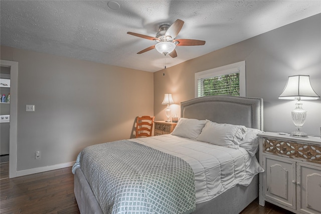 301 Chestnut Bnd, Huntsville, TX 77320 - bedroom with a textured ceiling, ceiling fan, dark wood finished floors, baseboards, and washer / clothes dryer