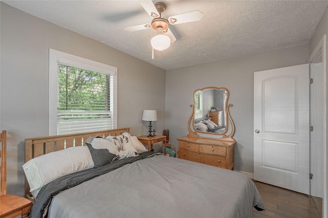 301 Chestnut Bnd, Huntsville, TX 77320 - bedroom featuring ceiling fan, baseboards, wood finished floors, and a textured ceiling