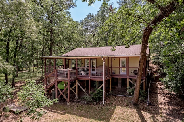 301 Chestnut Bnd, Huntsville, TX 77320 - back of house featuring stairway, roof with shingles, and a deck