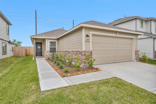 view of front facade featuring driveway, fence, a garage, brick siding, and a front yard