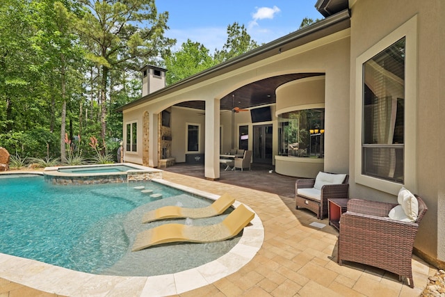 view of swimming pool featuring a ceiling fan, a patio, an outdoor living space, and a pool with connected hot tub