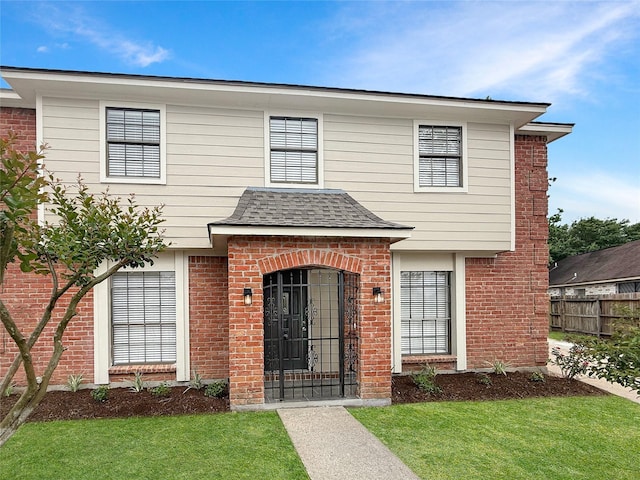 6223 Downwood Forest Dr, Houston, TX 77088 - view of front of property with roof with shingles, fence, a front lawn, and brick siding